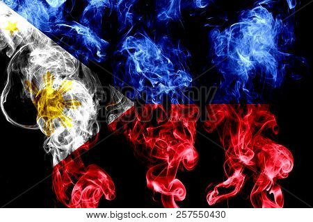 National Flag Of Philipines Made From Colored Smoke Isolated On Black Background