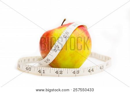 Apple And Centimeter On White Background. Isolated On White. White Ruler On Red Apple