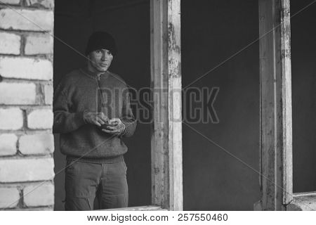 Homeless poor man in derelict building