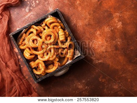 Curly Fries Fast Food Snack In Wooden Box On Kitchen Background. Unhealthy Junk Food