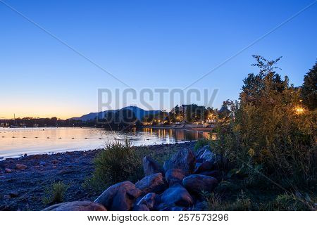 Magog, Province Of Quebec, Canada, September 2018. Beautiful Magog Town At Night In Reflections Of M