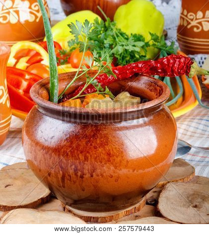 Traditional Rustic Home  Gulyas, With Raw Vegetables And Spices In Clay Pots On  Old Vintage Wooden 