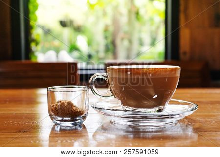 Hot Coffee Cup With Cane Sugar Cup On The Wooden Table, Window View