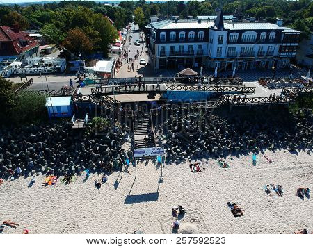 MIELNO, POLAND - 02 SEPTEMBER 2018 - Aerial view on sunny beach with tourists at baltic sea on Mielno city