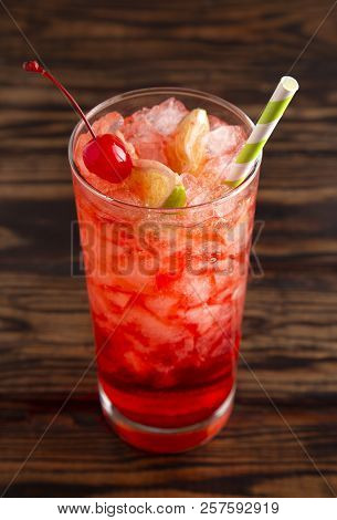 Glass Of Cold Refreshing Cherry Limeade On A Wooden Table