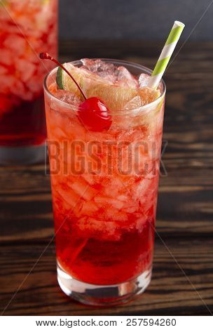 Glass Of Cold Refreshing Cherry Limeade On A Wooden Table