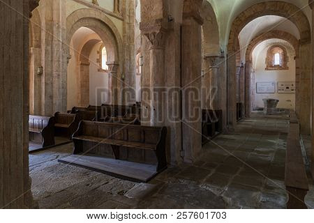 Gourdon, France - August 3, 2018: Interior With Pink Color, Wooden Benches And Huge Pilars Of The Ro