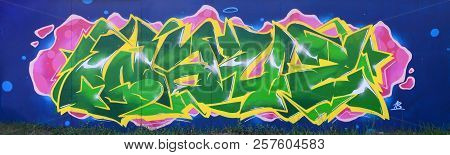 Full And Acomplished Graffiti Artwork. The Old Wall Decorated With Paint Stains In The Style Of Stre