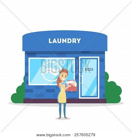 Woman With Dirty Clothes Standing In Front Of Laundry.