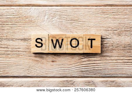 Swot Word Written On Wood Block. Swot Text On Table, Concept.