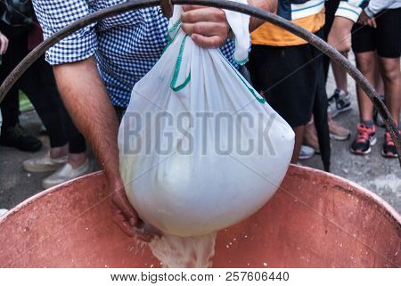 Cheesemaker Showing The Proceeding To Make Cheese From The Milk