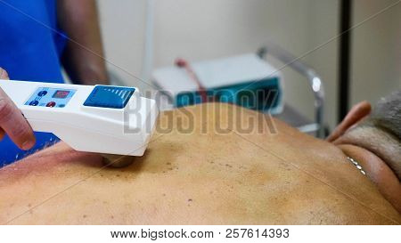 Senior Male Patient Receive Electrostatic Therapy Procedure On His Back.