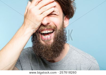 Facepalm. Happy Smiling Joyful Man Covering His Face. Shame And Fun Concept. Portrait Of A Young Bea