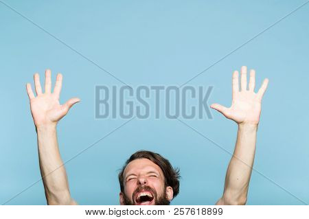 Happiness Enjoyment And Laugh. Excited Man With Hands In The Air. Portrait Of A Young Bearded Guy On