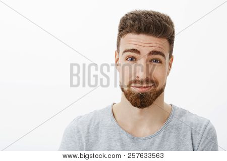 Close-up Shot Of Charming Kind And Charismatic Happy Bearded Man With Moustache Raising Eyebrows And