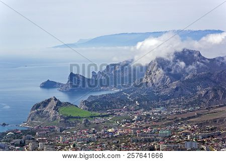 The Tops Of The Mountains Are Covered With Clouds. View From The Top Of Mount Ai-george (the Western