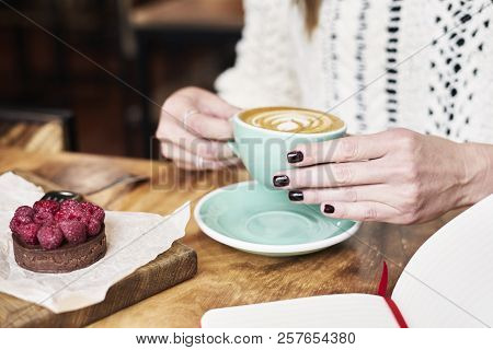 Having Lunch With Coffee Flat White And Sweet Chocolate Cookie In A Cafe Or Restaurant. Woman Hands 