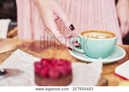Cup Of Coffee Latte And Sweet Pastry On Wooden Table In Woman Hands. Gentle Romantic Mood, Girl Wear