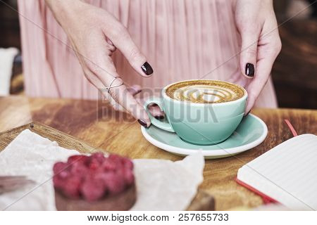 Cup Of Coffee Latte And Sweet Pastry On Wooden Table In Woman Hands. Gentle Romantic Mood, Girl Wear
