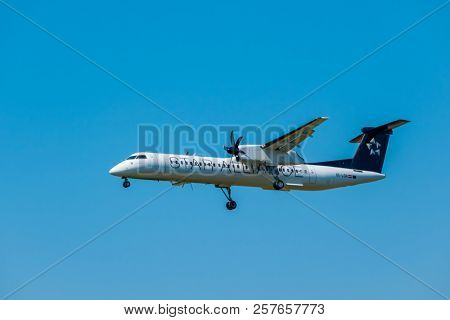 Zurich, Switzerland - July 19, 2018: Star alliance airlines Bomardier Dash 8 Q400 airplane preparing for landing at day time in international airport