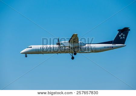 Zurich, Switzerland - July 19, 2018: Star alliance airlines Bomardier Dash 8 Q400 airplane preparing for landing at day time in international airport