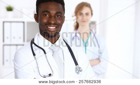 Happy African American Male Doctor  With Medical Staff At The Hospital. Medicine Concept