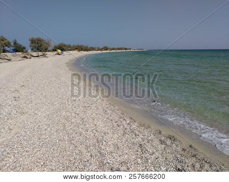 A View Of The Coast From The Black Sea On The Island Of Dzharylgach. Crystal Clear Water, White Sand
