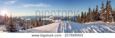 Ski Tracks Dropping Off A Ridge, Looking Out Onto The Mountains Near Whistler, Bc.