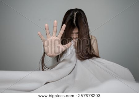 The Palm Of A Female Hand Giving The Signal To Stop.  Moody Image Is A Concept Of A Woman Being Abus