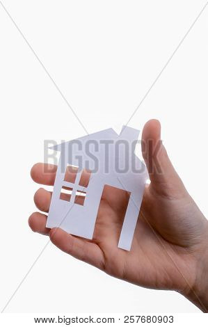 Hand Holding An Isolated Paper House With A White Background