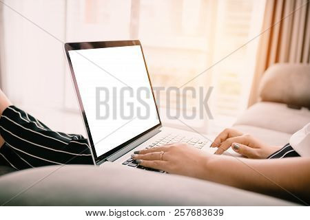 Close Up Woman Hand Typing Trackpad And Sitting On Chaise Longue And Using Laptop Blank Screen At Ho