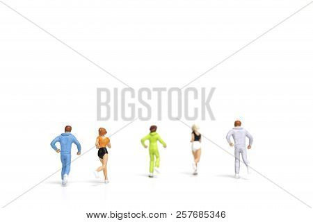 Miniature People Running On White Background , Healthy Lifestyle And Sport Concepts.