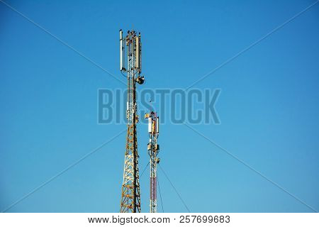 Telephone Antenna On Clear Blue Sky Background. Sunny Day. 4g And 4.5g Cell Site, Telecom Radio Towe