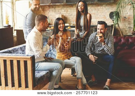 Spending Great Time With Best Friends. Group Of Cheerful Young People Enjoying Food And Drinks While