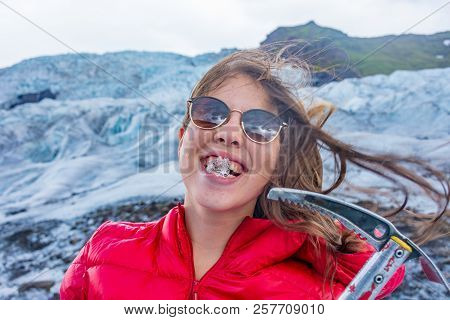 Young Woman With An Ice Axe On The Vatnajokull Glacier  Blue Ice Tour, Iceland