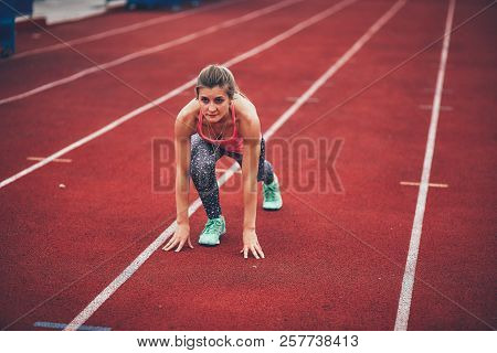 Muscular And Beautiful Girl Doing Exercises. Athletics Girl, Stadium