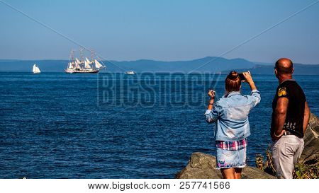 Tourists Take A Photo During The Movement Of Ships In The Amur Bay Of The Bosporus Vostochny Strait 