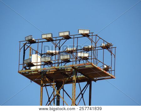 Powerful Illumination System Mounted On High Mast On The Blue Sky Background Closeup