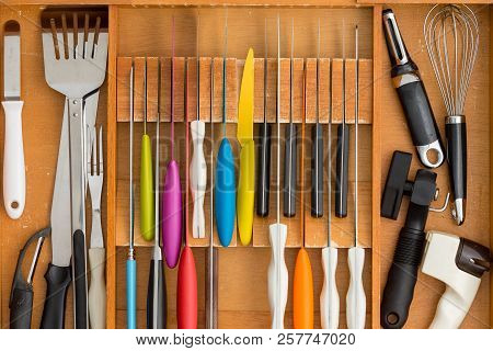 Fitted Knife Drawer In A Wooden Kitchen Cabinet With A Neat Array Of Knives With Assorted Cooking Ut