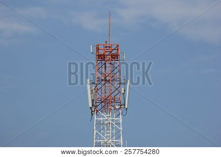 Mobile Phone Tower With Blue Sky And Airplane Background