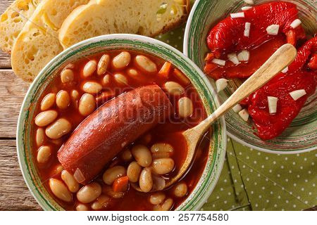Bean Soup With Sausage Served With Pickled Pepper And Garlic Close-up. Horizontal Top View