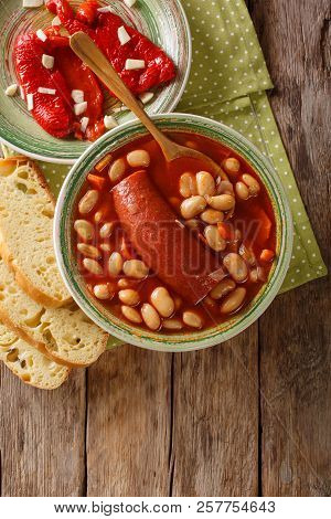 Traditional Balkan Food: Pasulj Bean Soup With Sausage Close-up On A Plate. Vertical Top View