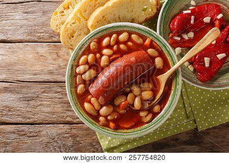 Traditional Balkan Food: Pasulj Bean Soup With Sausage Close-up On A Plate. Horizontal Top View