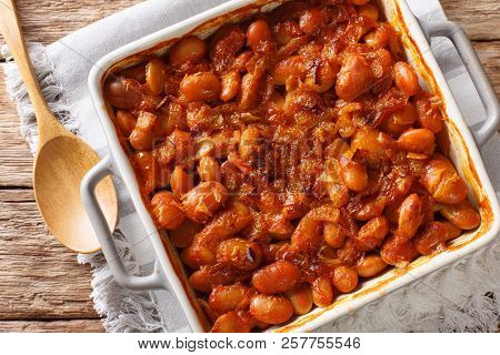 Delicious Prebranac Baked Beans With Onions Close-up On A Table. Horizontal Top View From Above