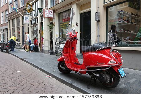 Amsterdam, Netherlands - July 8, 2017: Red Piaggio Vespa Scooter Parked In Amsterdam, Netherlands. V
