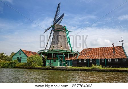 Traditional, Authentic Dutch Windmill At The River Zaam In Zaanse Schans Village.