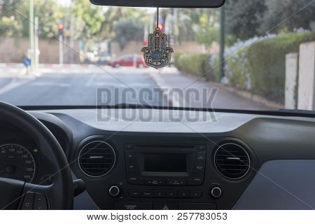 Hamsa Hand Amulet Hanging In The Car, Due To Belief Of Jewish People About Good Luck.