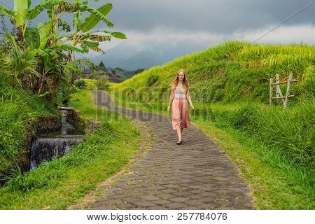 Young Woman Traveler On Beautiful Jatiluwih Rice Terraces Against The Background Of Famous Volcanoes