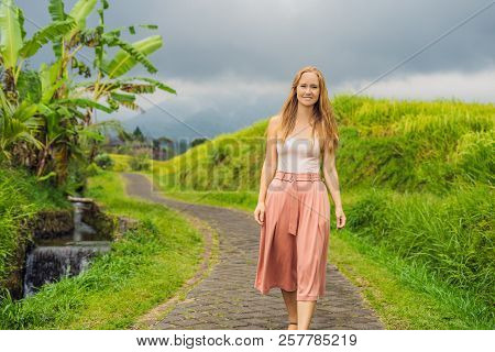 Young Woman Traveler On Beautiful Jatiluwih Rice Terraces Against The Background Of Famous Volcanoes