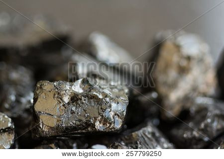 Black Coal Mine Close-up With Soft Focus. Anthracite Coal Bar On Dark Background